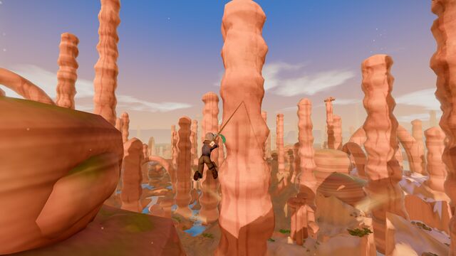 Hanging from a rope among tall red sandstone spires