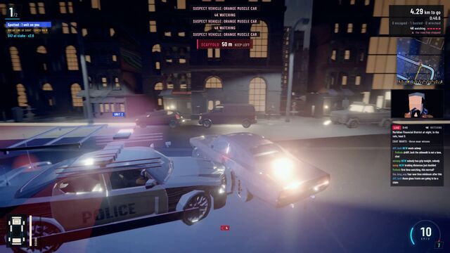 Police cruisers swarm a car on a city street at night, with dispatch calls for the orange muscle car on screen (full size, 1920 × 1080)